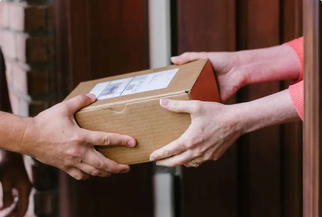 Monthly medication delivery handed to a customer at their door