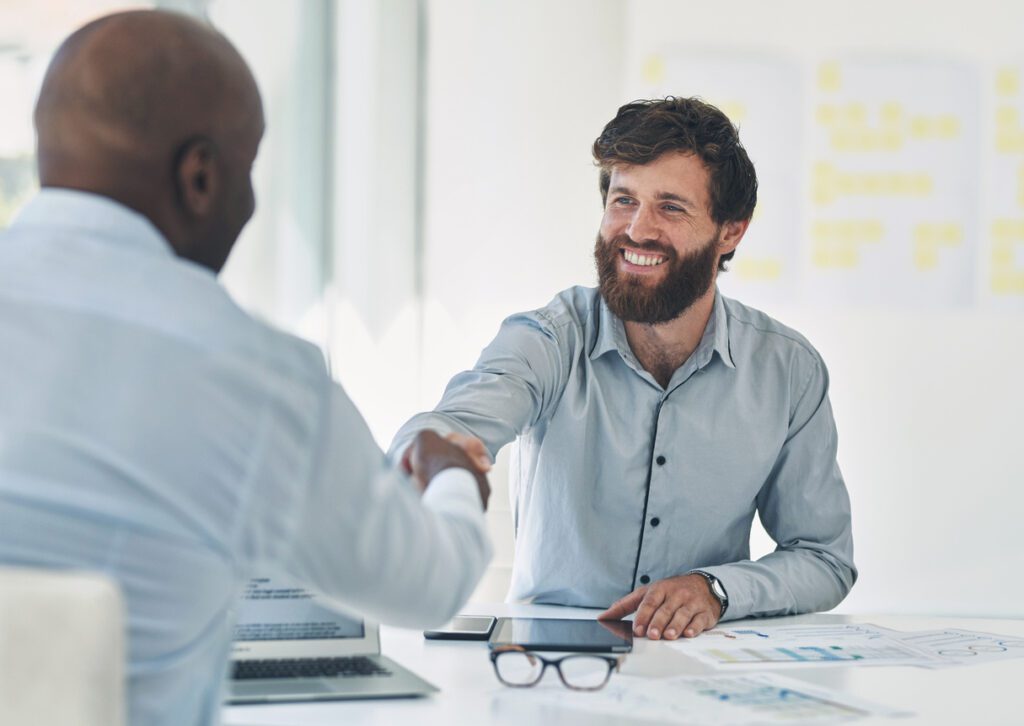 Shot of two businesspeople shaking hands during a meeting in an office