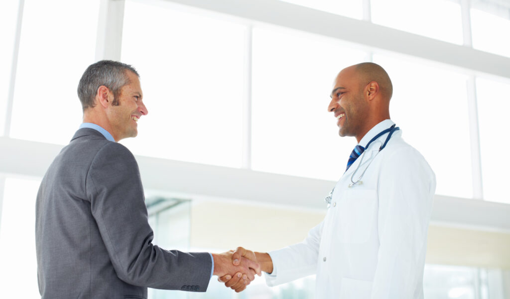 Mature administrator shaking hands with a doctor