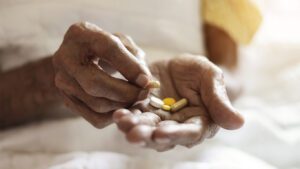 pills in a Senior's oldman hands. Painful old age. Caring for the health of the elderly